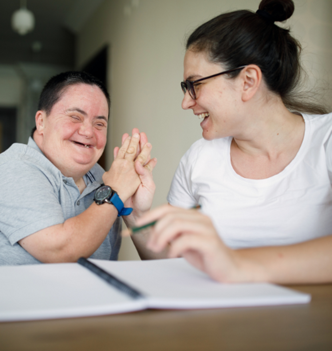 Support Worker high-fiving a client.