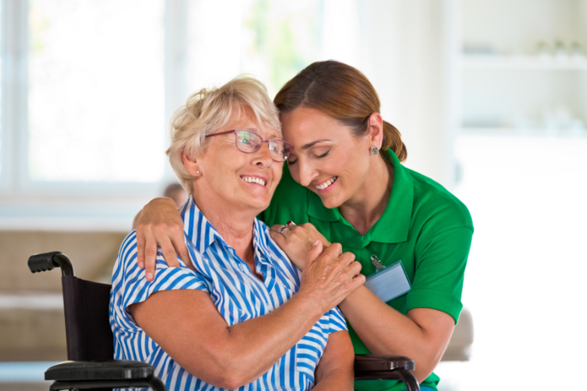 Support Worker hugging an elderly client.