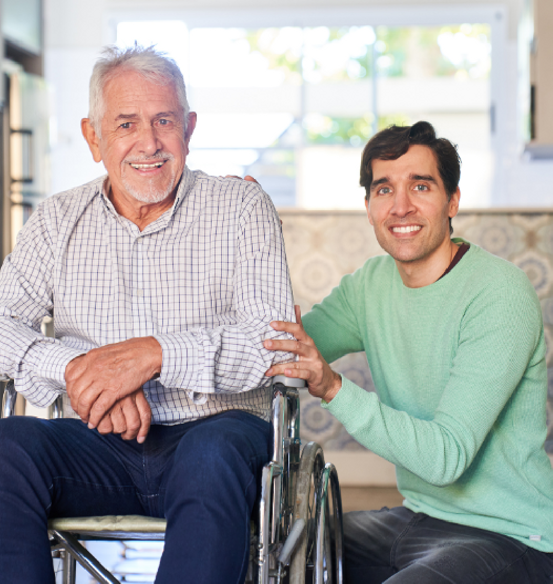 Client and his Support Worker smiling for a photo.